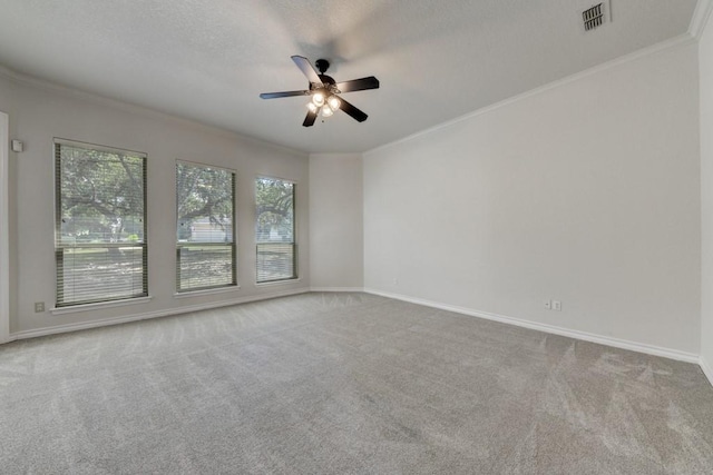 unfurnished room featuring light carpet, ceiling fan, ornamental molding, and a textured ceiling