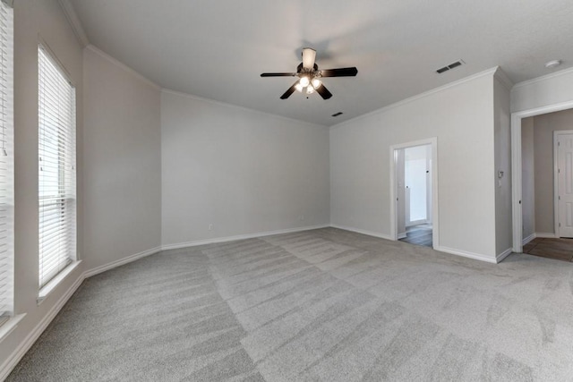 carpeted empty room with ceiling fan and ornamental molding