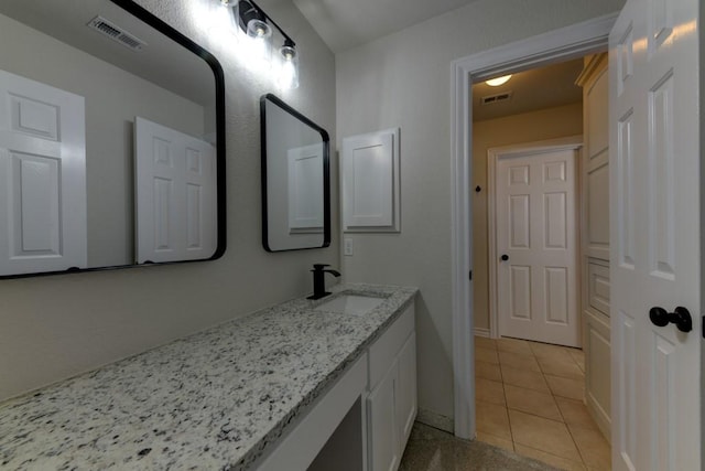 bathroom with tile patterned floors and vanity