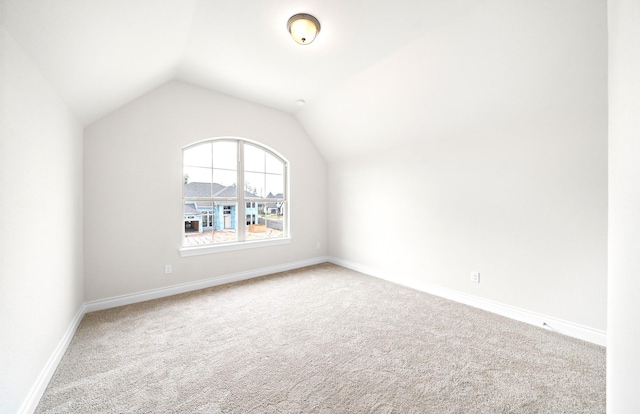 interior space featuring carpet floors and vaulted ceiling