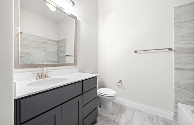 full bathroom featuring bathtub / shower combination, vanity, and toilet