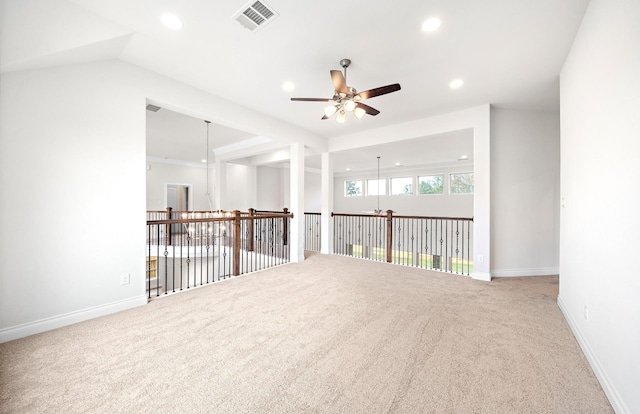 carpeted spare room featuring ceiling fan