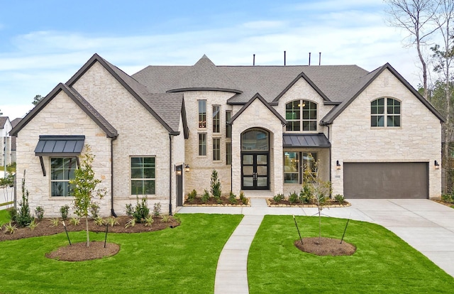 french country style house featuring a garage and a front yard