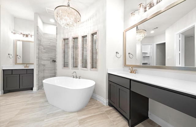 bathroom featuring a bathtub, vanity, and an inviting chandelier