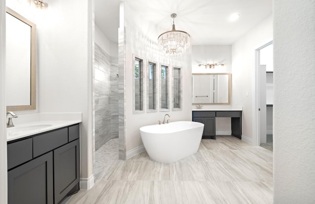 bathroom with a chandelier, vanity, and independent shower and bath