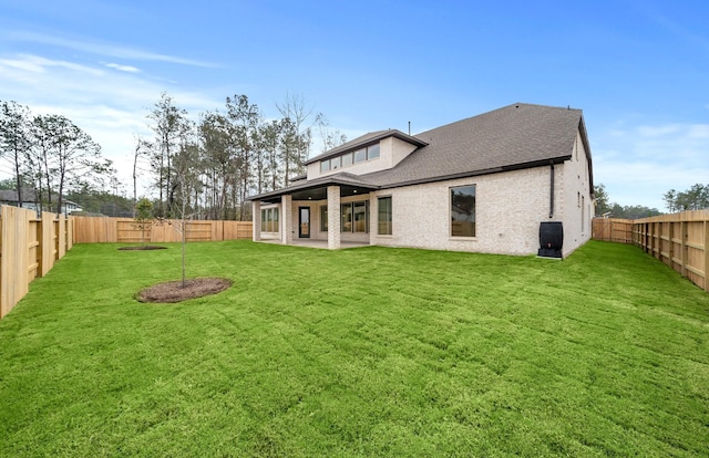 rear view of house featuring a patio and a lawn