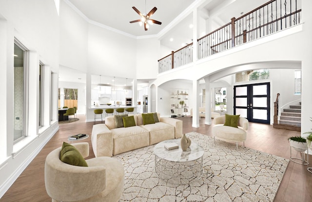 living room featuring crown molding, french doors, high vaulted ceiling, and dark wood-type flooring