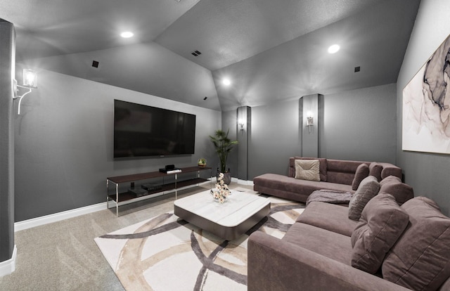 home theater featuring light colored carpet and vaulted ceiling