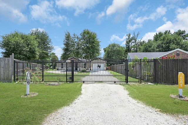 view of gate featuring a lawn