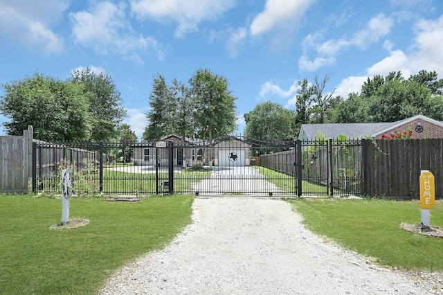 view of gate featuring a yard