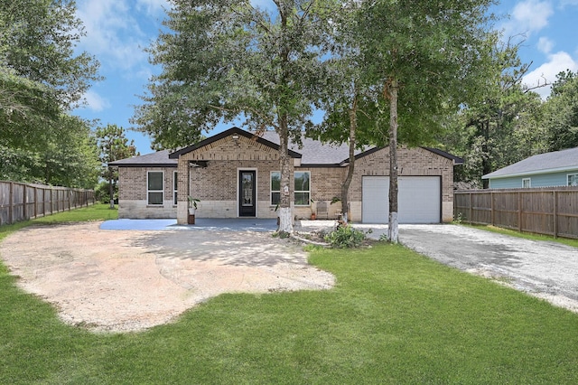 view of front of property featuring a garage and a front lawn