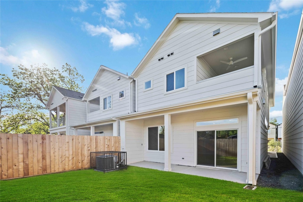 back of house with a yard, ceiling fan, and a patio area