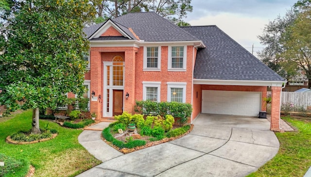 view of front of home featuring a front yard and a garage