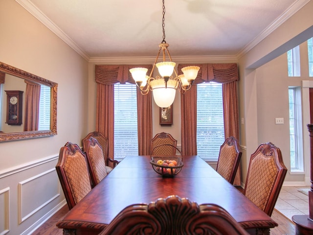 dining space with ornamental molding, a notable chandelier, and a healthy amount of sunlight