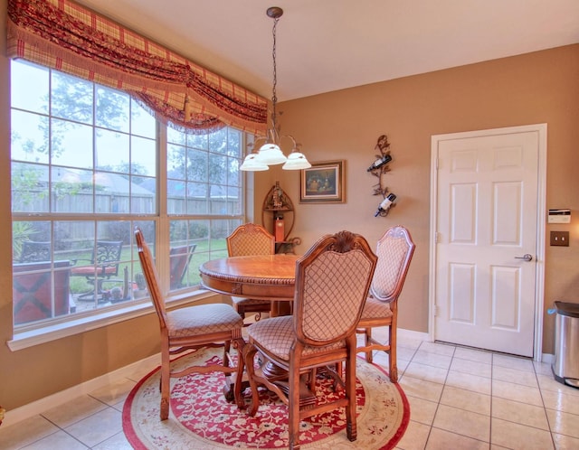 dining space featuring light tile patterned floors and a chandelier