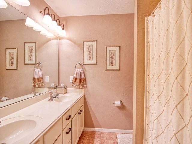 bathroom with a textured ceiling, vanity, tile patterned floors, and curtained shower