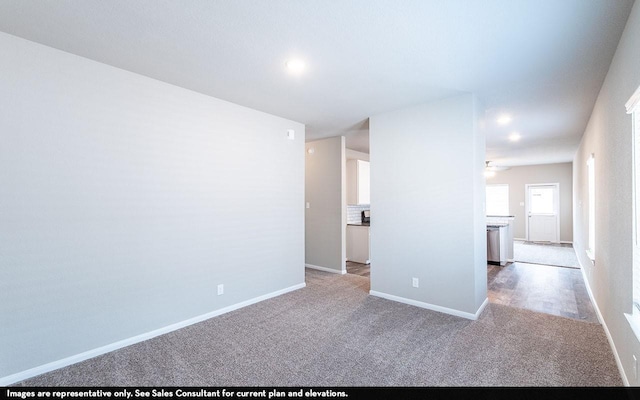 carpeted spare room with ceiling fan