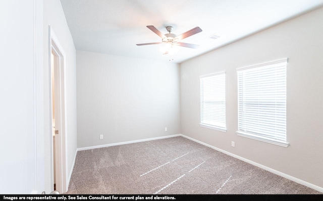 carpeted spare room featuring ceiling fan