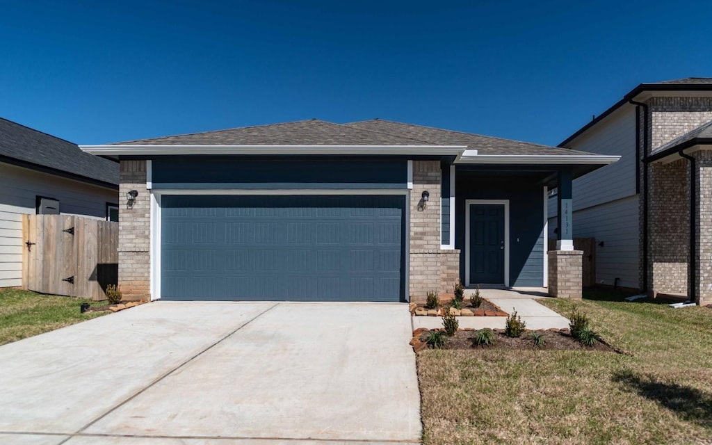 view of front of house featuring a shingled roof, concrete driveway, an attached garage, fence, and brick siding