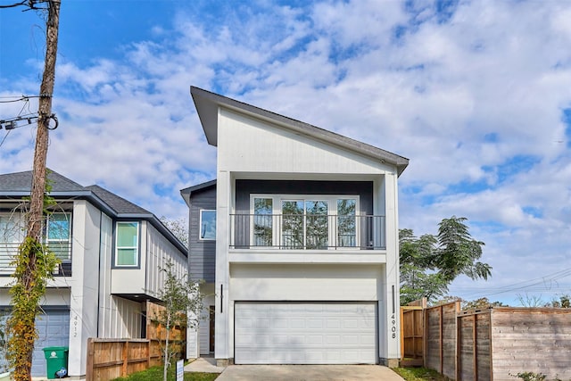 view of front of property with a garage and a balcony