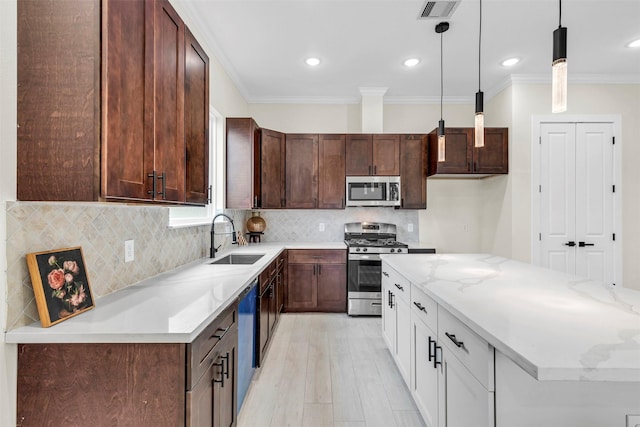 kitchen featuring sink, stainless steel appliances, pendant lighting, white cabinets, and ornamental molding