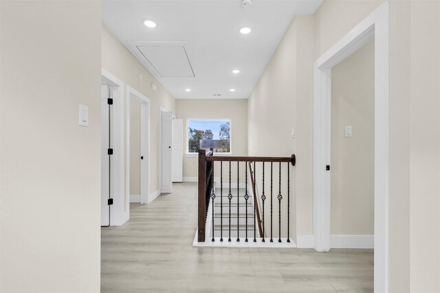 hallway with light hardwood / wood-style floors