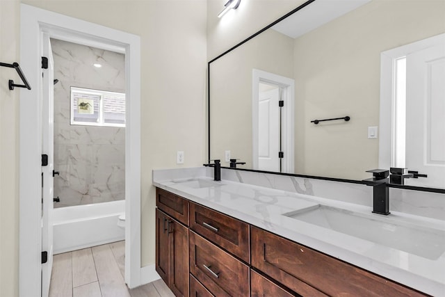 full bathroom with wood-type flooring, vanity, toilet, and tiled shower / bath