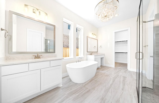 bathroom with vanity, an inviting chandelier, and independent shower and bath