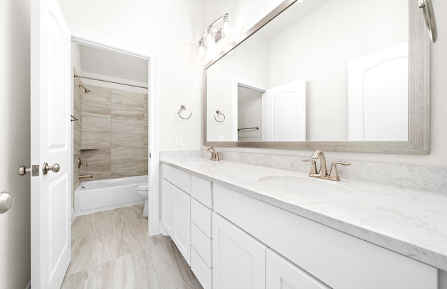 full bathroom featuring vanity, toilet, and tiled shower / bath