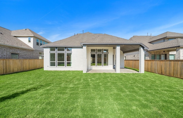 back of property featuring a lawn and a patio