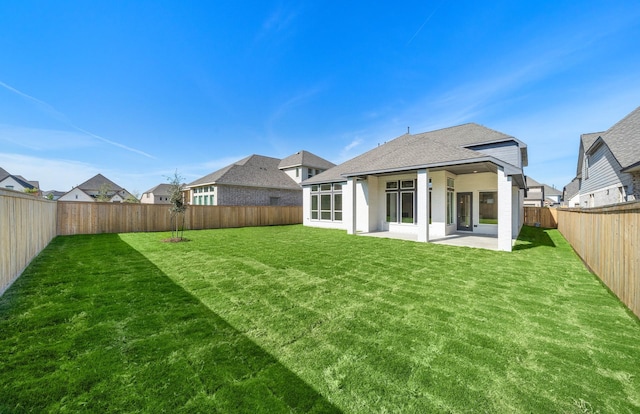 back of property featuring a lawn and a patio