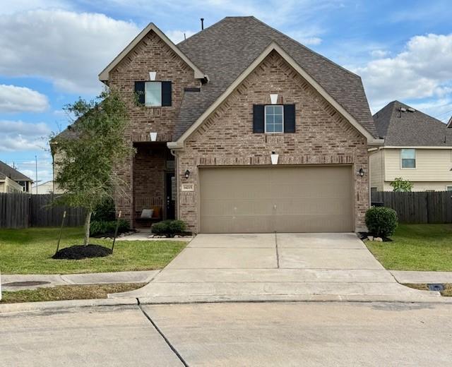 view of front of home featuring a garage and a front lawn