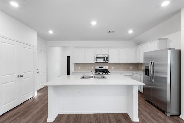 12305 Delta Timber Rd, Conroe, TX 77304 - kitchen featuring appliances with stainless steel finishes, a sink, a kitchen island with sink, backsplash, and light countertops