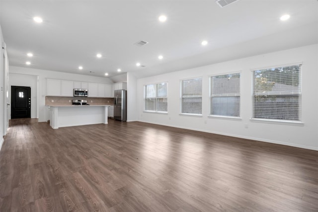 12305 Delta Timber Rd, Conroe, TX 77304 - unfurnished living room featuring baseboards, recessed lighting, and dark wood-type flooring