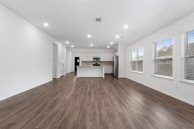 12305 Delta Timber Rd, Conroe, TX 77304 - unfurnished living room featuring dark wood-style floors, baseboards, and recessed lighting