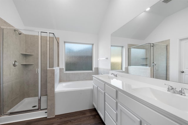 12305 Delta Timber Rd, Conroe, TX 77304 - full bath featuring lofted ceiling, a shower stall, a garden tub, wood finished floors, and double vanity