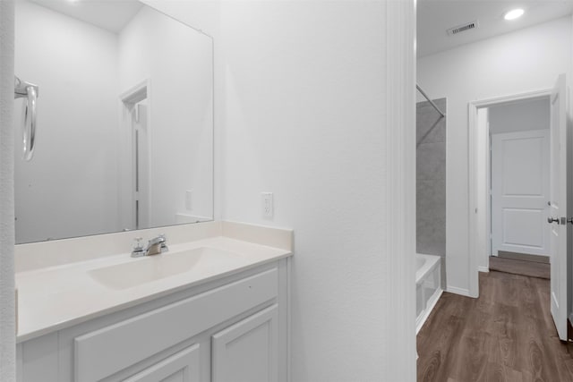 12305 Delta Timber Rd, Conroe, TX 77304 - full bathroom featuring wood finished floors, vanity, recessed lighting, and tub / shower combination