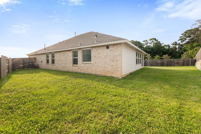 12305 Delta Timber Rd, Conroe, TX 77304 - rear view of property featuring central AC unit, brick siding, and a shingled roof