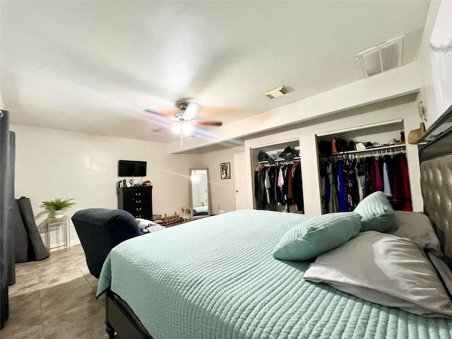 bedroom featuring two closets and ceiling fan