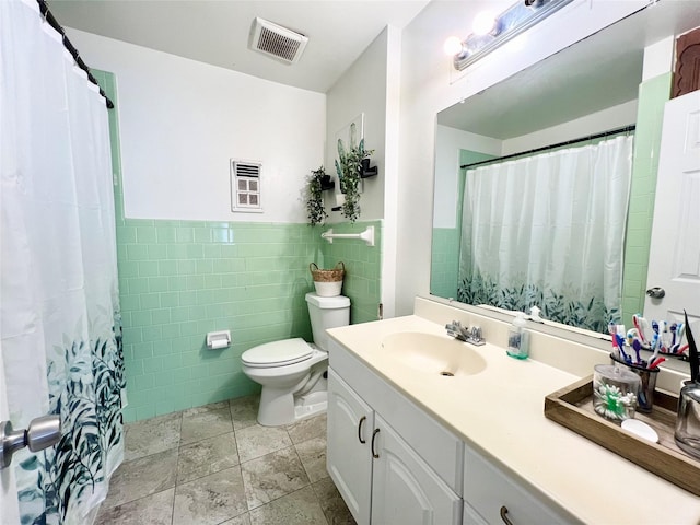 bathroom with vanity, a shower with shower curtain, tile walls, and toilet