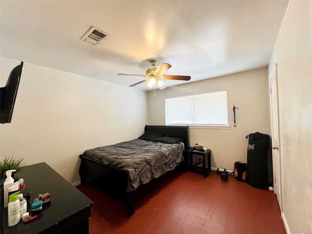 bedroom with dark hardwood / wood-style floors and ceiling fan