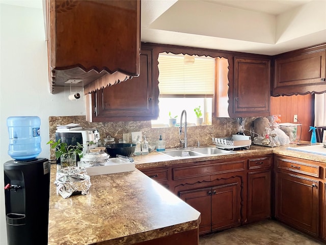 kitchen with tasteful backsplash, sink, light tile patterned flooring, and extractor fan