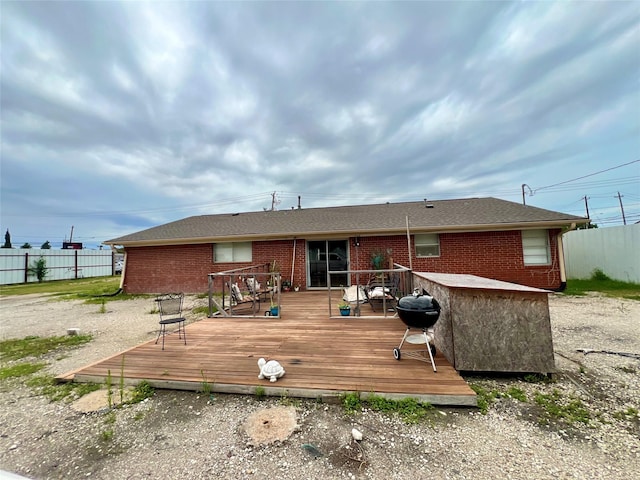 back of property with a wooden deck