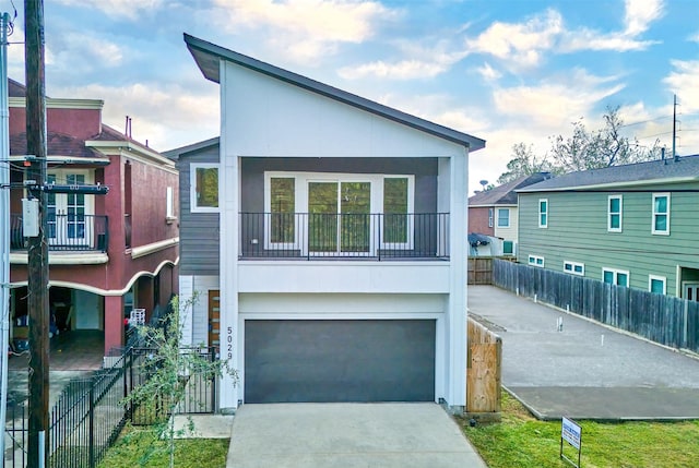 view of front of property featuring a balcony and a garage