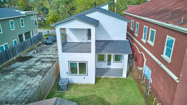 rear view of property featuring a yard