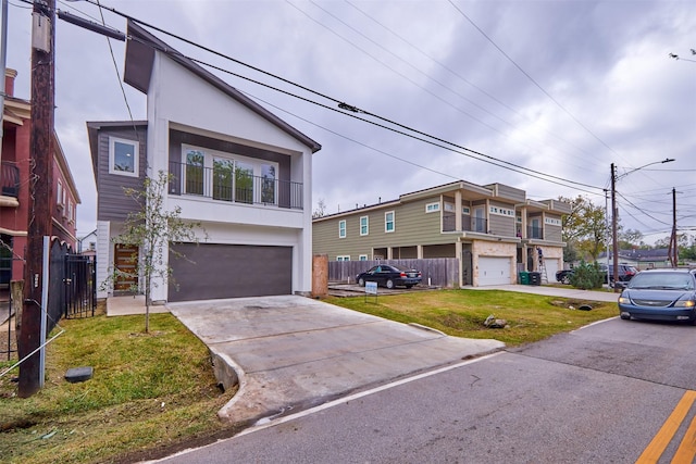 view of front of home with a garage and a front lawn