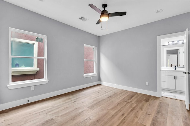 unfurnished bedroom with ensuite bath, ceiling fan, and light hardwood / wood-style floors