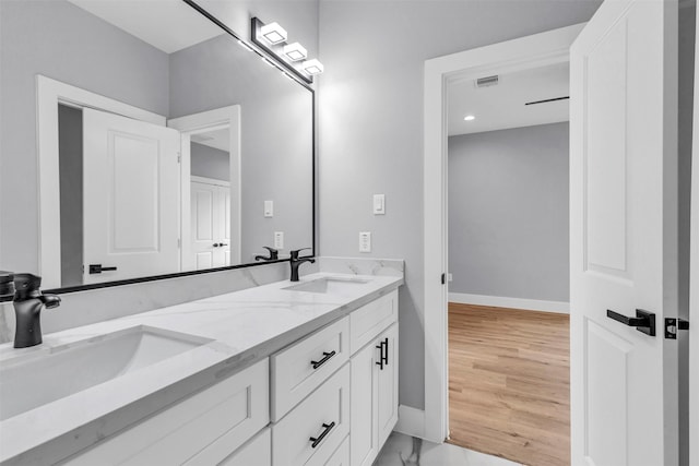 bathroom with hardwood / wood-style floors and vanity