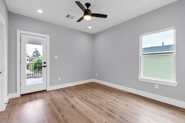 empty room with ceiling fan and light hardwood / wood-style floors