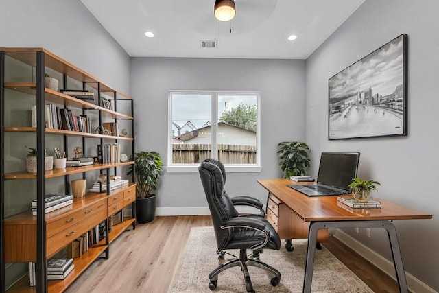 home office with ceiling fan and light wood-type flooring